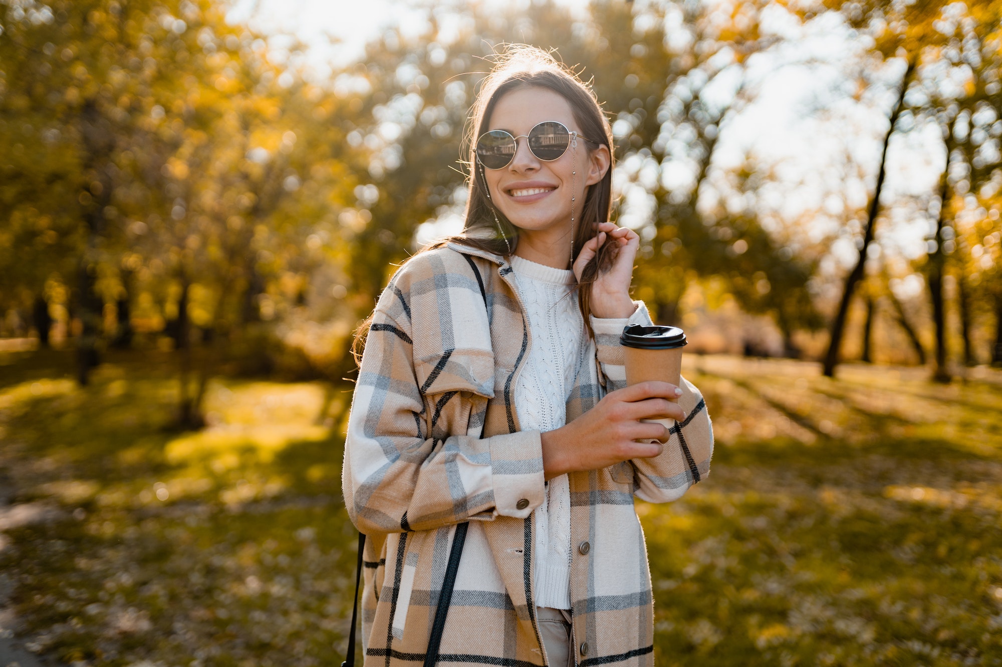 attractive young woman walking in autumn wearing jacket